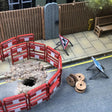 A OO gauge/OO scale roadworks scene with temporary traffic signs and folding road barriers.